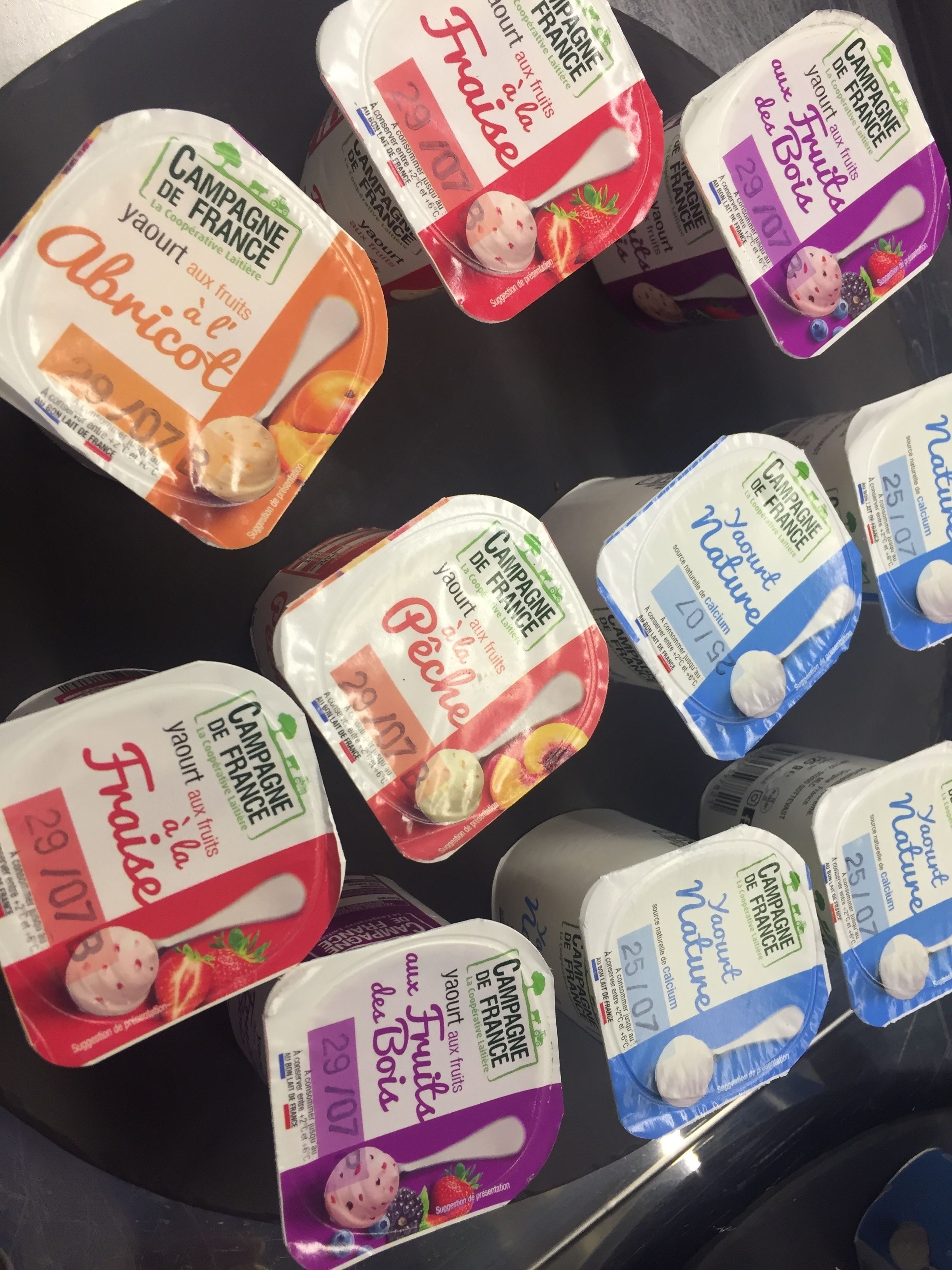 A variety of yogurt containers with different flavors and packaging designs.