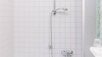 A modern bathroom with a bathtub, a shower, and a sink.