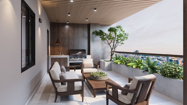 A modern outdoor patio with a built-in grill, seating area, and a view of the cityscape. - K-Zone The Star Hotel (Hai Phong)