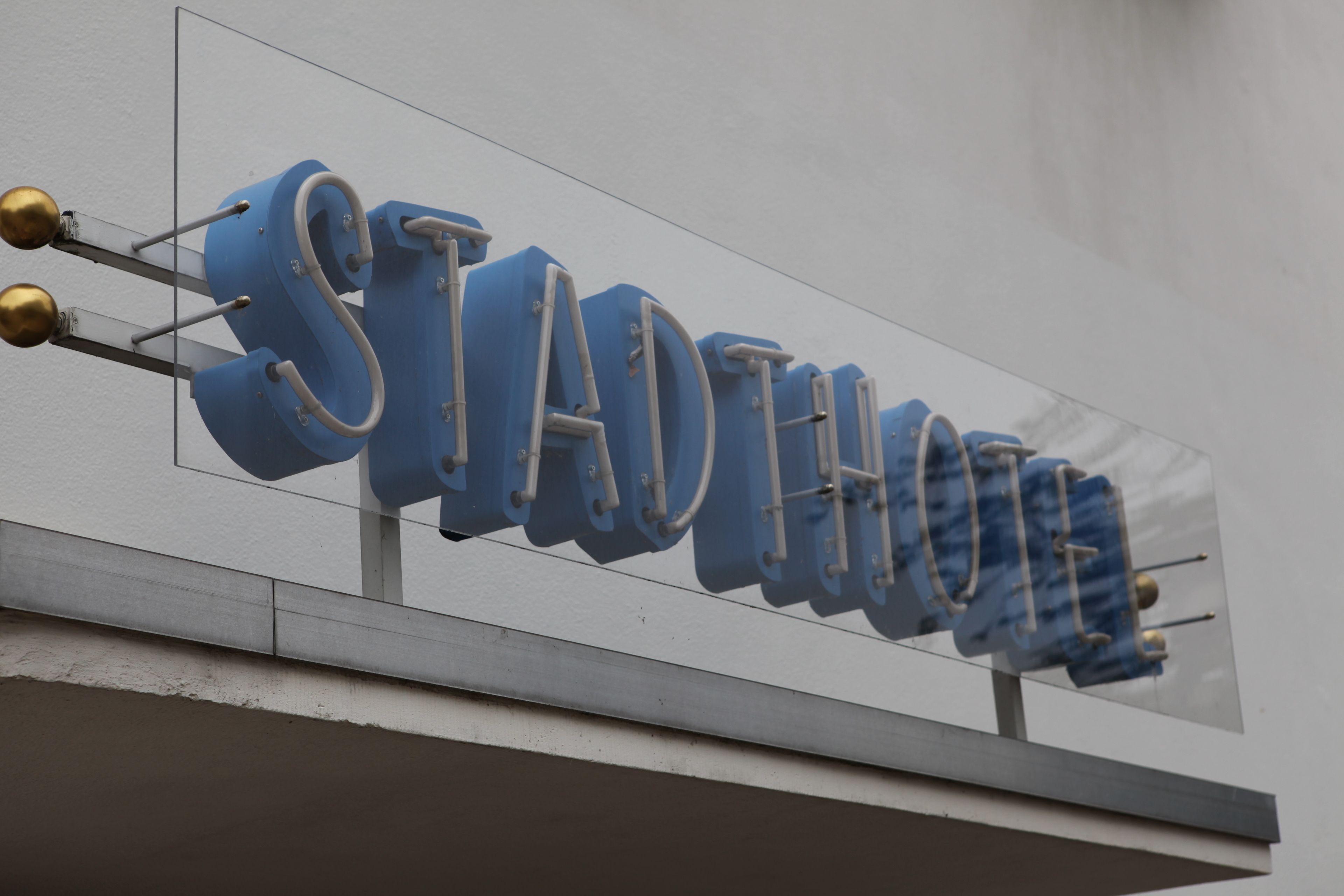 A sign with the word "STADTHOUSE" in large, bold letters.