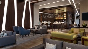 A modern hotel lobby with a bar area, seating arrangements, and a dining space. - Sheraton Istanbul City Center (Istanbul)