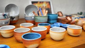 A variety of small ceramic bowls and cups arranged on a wooden surface.