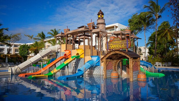 A water park with multiple slides and a themed structure.