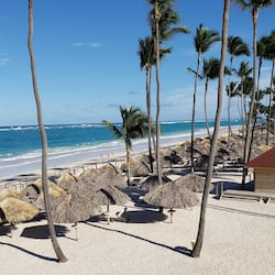 On the beach, white sand, beach umbrellas, beach towels