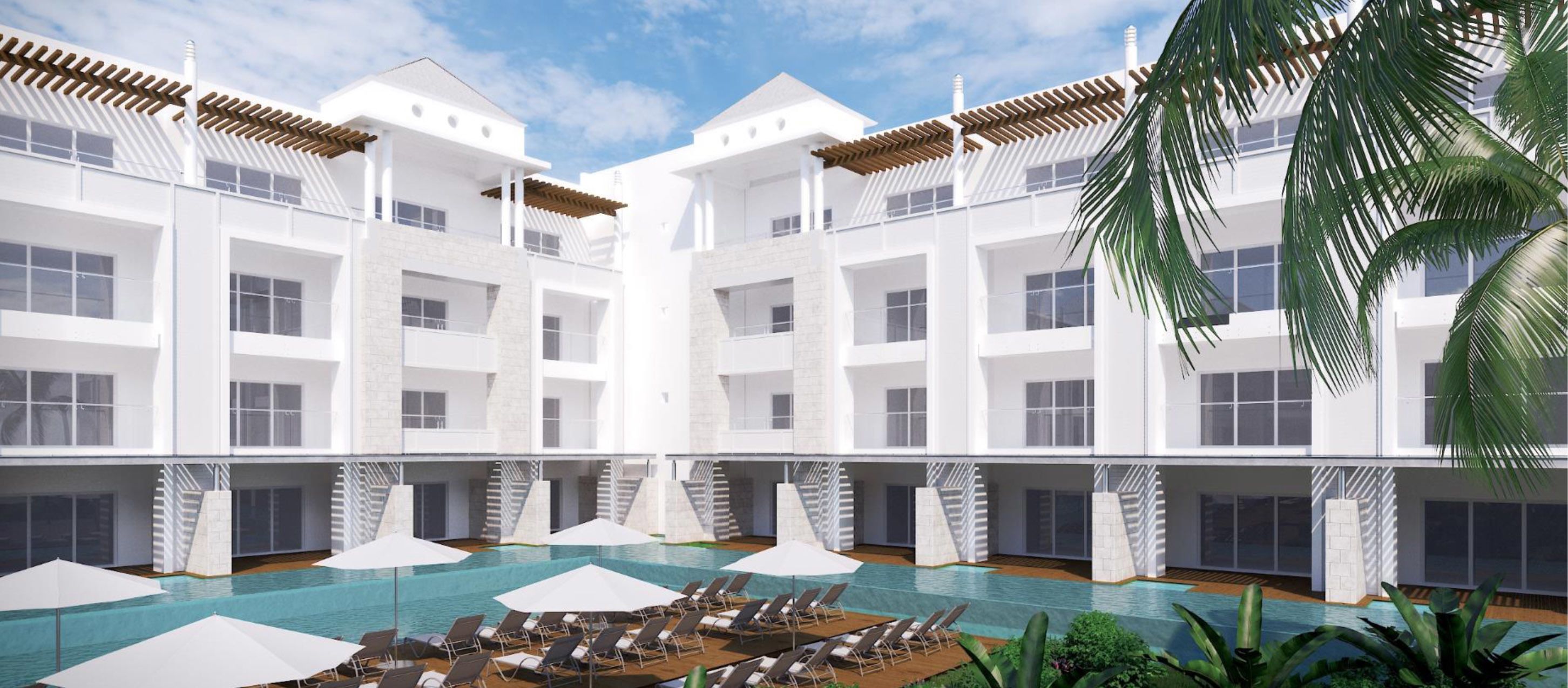 Et moderne hotel med poolområde, flere etager og en tropisk have.