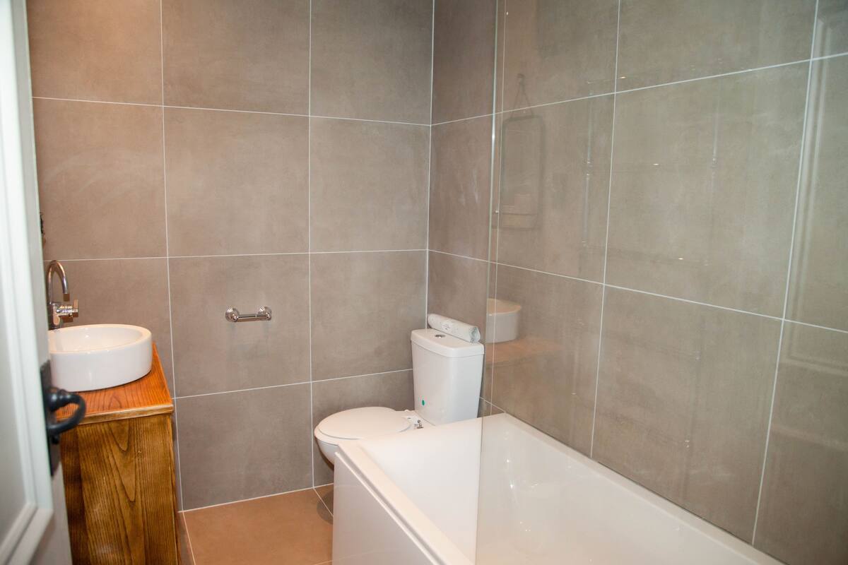 A bathroom with a toilet, sink, and bathtub.