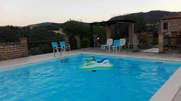 Seasonal outdoor pool, open 8:00 AM to 8:30 PM, pool umbrellas