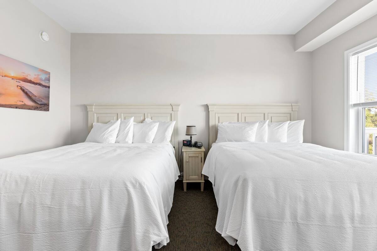 Premium bedding, pillow-top beds, desk, laptop workspace