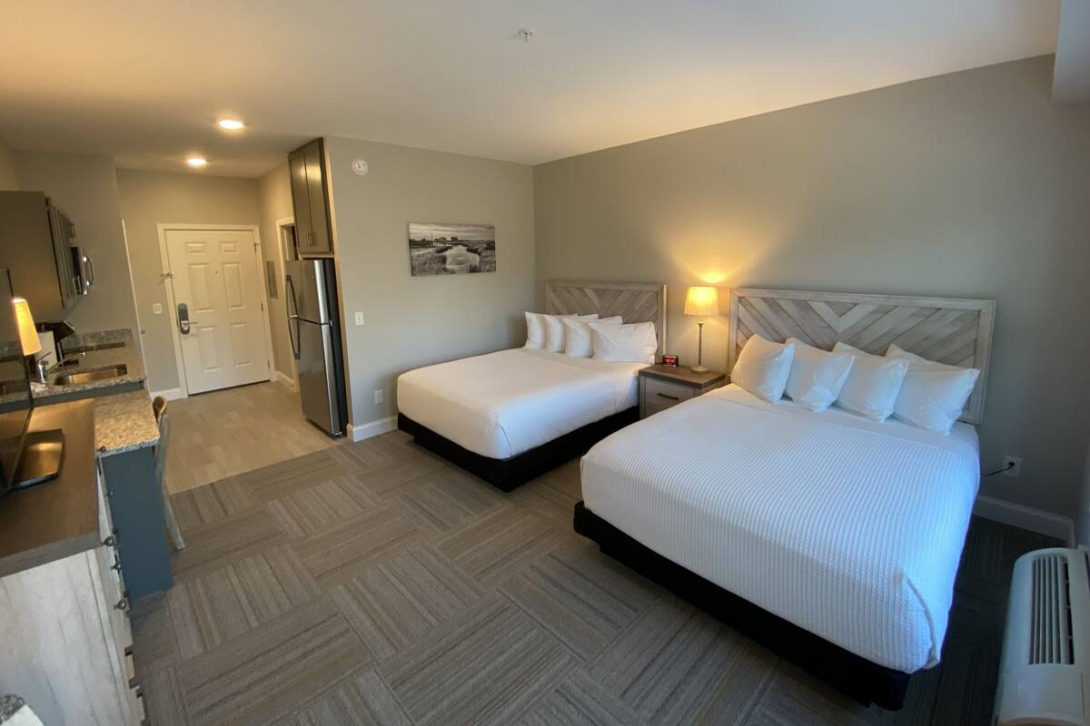 Premium bedding, pillow-top beds, desk, laptop workspace
