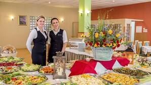 A buffet setup with various food items and a centerpiece. - Millennium Spa (Dziwnów)