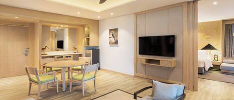 A modern hotel room with a dining area, a TV, a ceiling fan, and a bed.
