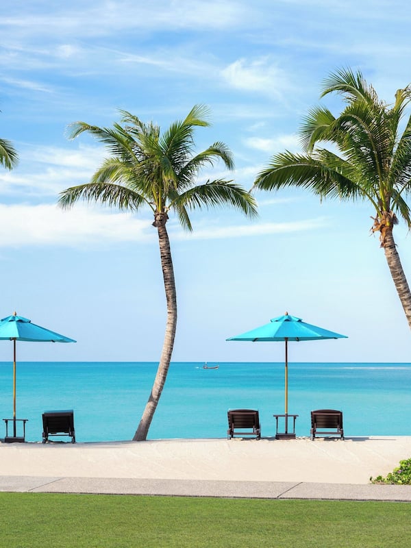 On the beach, white sand, sun loungers, beach umbrellas