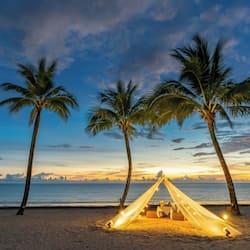 On the beach, white sand, sun loungers, beach umbrellas