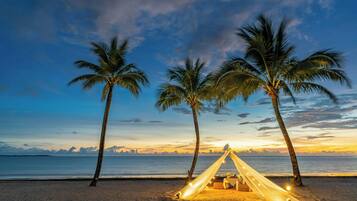 On the beach, white sand, sun-loungers, beach umbrellas