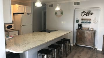 Microwave, dishwasher, coffee/tea maker, cookware/dishes/utensils