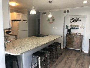 Microwave, dishwasher, coffee/tea maker, cookware/dishes/utensils