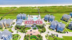 A resort with multiple buildings, a central pool area, and a beach view. - Time Away Book 5+ nights & get 15% discount-Near Lazy River-3BD/2BA. Sleeps 9 (Galveston)