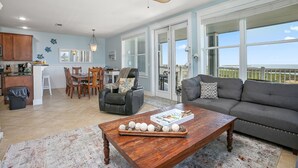 A spacious living area with a dining table, a sofa, and a ceiling fan. - Time Away Book 5+ nights & get 15% discount-Near Lazy River-3BD/2BA. Sleeps 9 (Galveston)