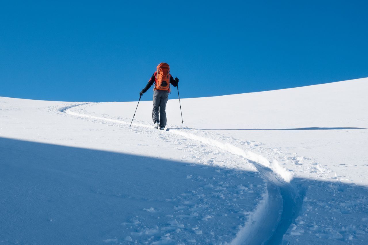 A person hiking in a snowy landscape.