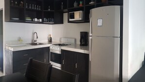 Junior Suite | Private kitchen | Coffee/tea maker, full-size fridge, microwave, oven - Brisas Suites Condo (Cancun)