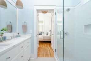 Bathtub, hair dryer, towels, toilet paper