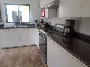 Villa | Private kitchen | Full-sized fridge, microwave, oven, stovetop