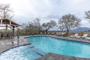 A swimming pool with lounge chairs and a pergola. - Gorgeous Vineyard Views, Large private home w/heated Pool & Hot Tub included! (Glen Ellen)