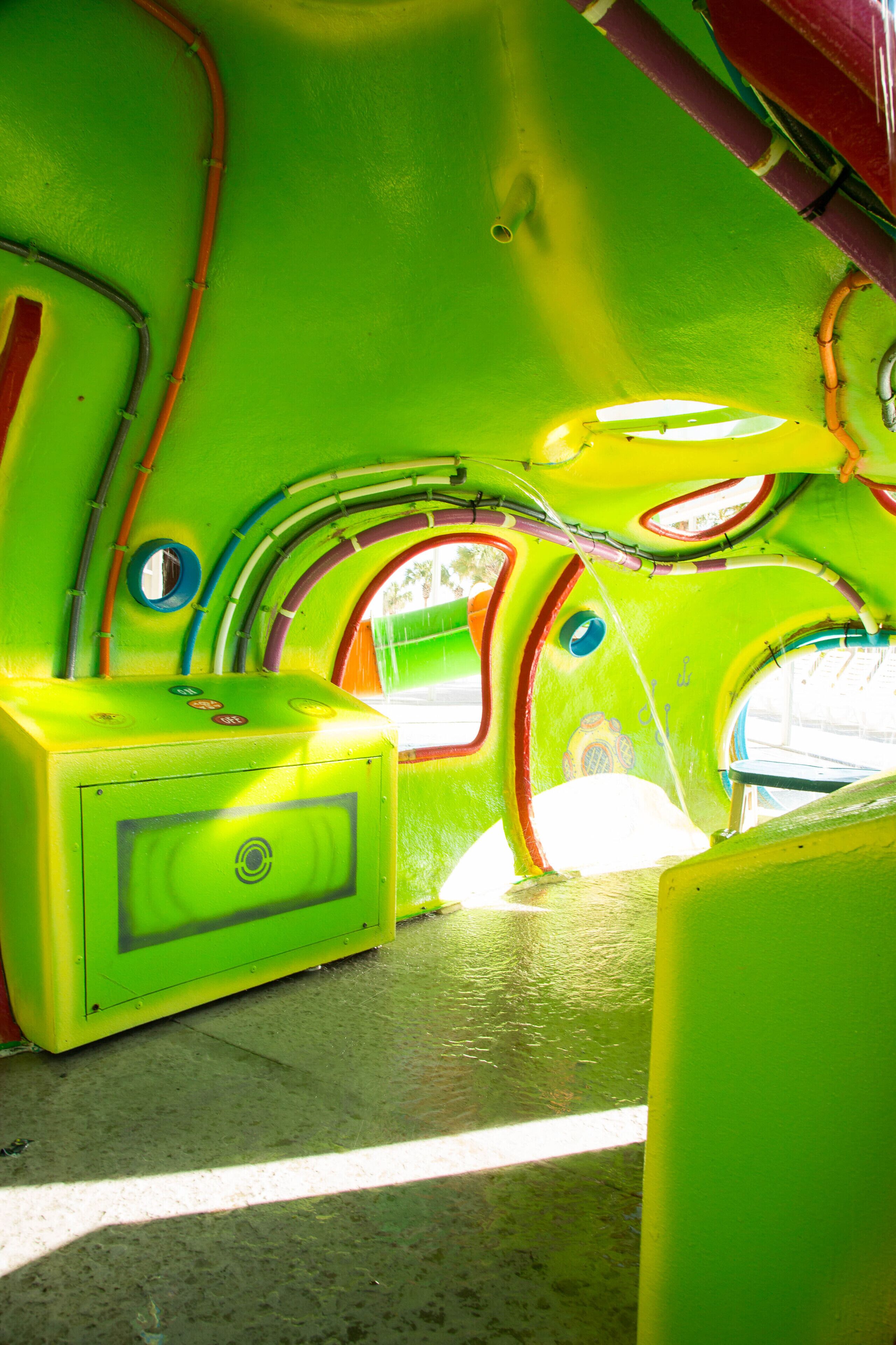 A brightly colored interior with a curved ceiling and a single window.