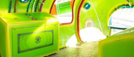 A brightly colored interior with a curved ceiling and a single window.