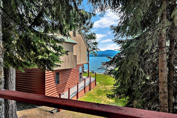 A cabin with a view of a lake and mountains. - Vintage 1940s McCall Lakefront Cabin |Boat Slip (McCall)