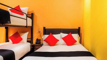 A hotel room with a bunk bed, a single bed, and a nightstand with a phone.