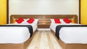 A double room with two beds, each with red and white bedding, a wooden headboard, and a small bedside table. - Capital O Df Inn, Ciudad de Mexico (Mexico City)