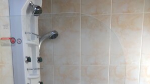 A shower with a control panel and a hand shower head. - TerrazaMar EcoCabañas (Quintero)