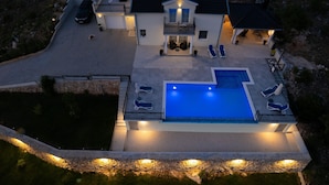 A modern two-story house with a swimming pool, outdoor seating, and a car parked in the driveway. - Beautiful villa with heated pool in Poljica Imotski - 8 people (Poljica)