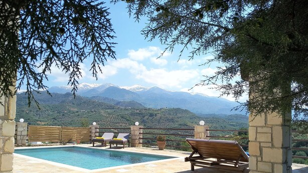 A pool area with lounge chairs and a view of snow-capped mountains. - Little House on the Prairie - Private Pool (Chania)