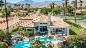 A residential property with a swimming pool, patio furniture, and a view of mountains. - Rancho La Quinta Country Club Spanish Beauty w/ Detached Casita  (La Quinta)
