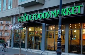 Shop at this Whole Foods Market, featuring a modern exterior with large glass windows and a prominent sign.