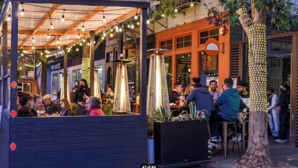 An outdoor dining area with string lights, a covered seating area, and a tree decorated with lights. - Walkable Urban Retreat - 2 En-Suite Baths - Near Top Dining & Shops & Hotspots! (SF)