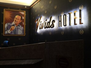 A hotel interior with a prominent 'Winds Hotel' sign and a framed portrait on the wall. - Vivids Hotel (Kuala Lumpur)