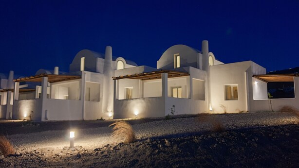 A modern white building with multiple domed structures and a covered patio area. - Bianco Diverso Suites (Santorini)
