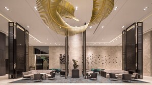 A modern lobby with a unique spiral ceiling design, comfortable seating areas, and a central sculpture. - Lakeshore Hotel Tainan (Tainan)