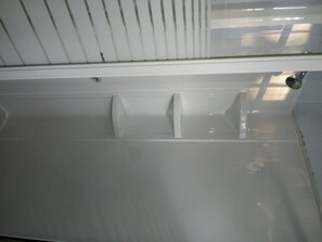 Bathroom features a bathtub and two sinks with a window above.