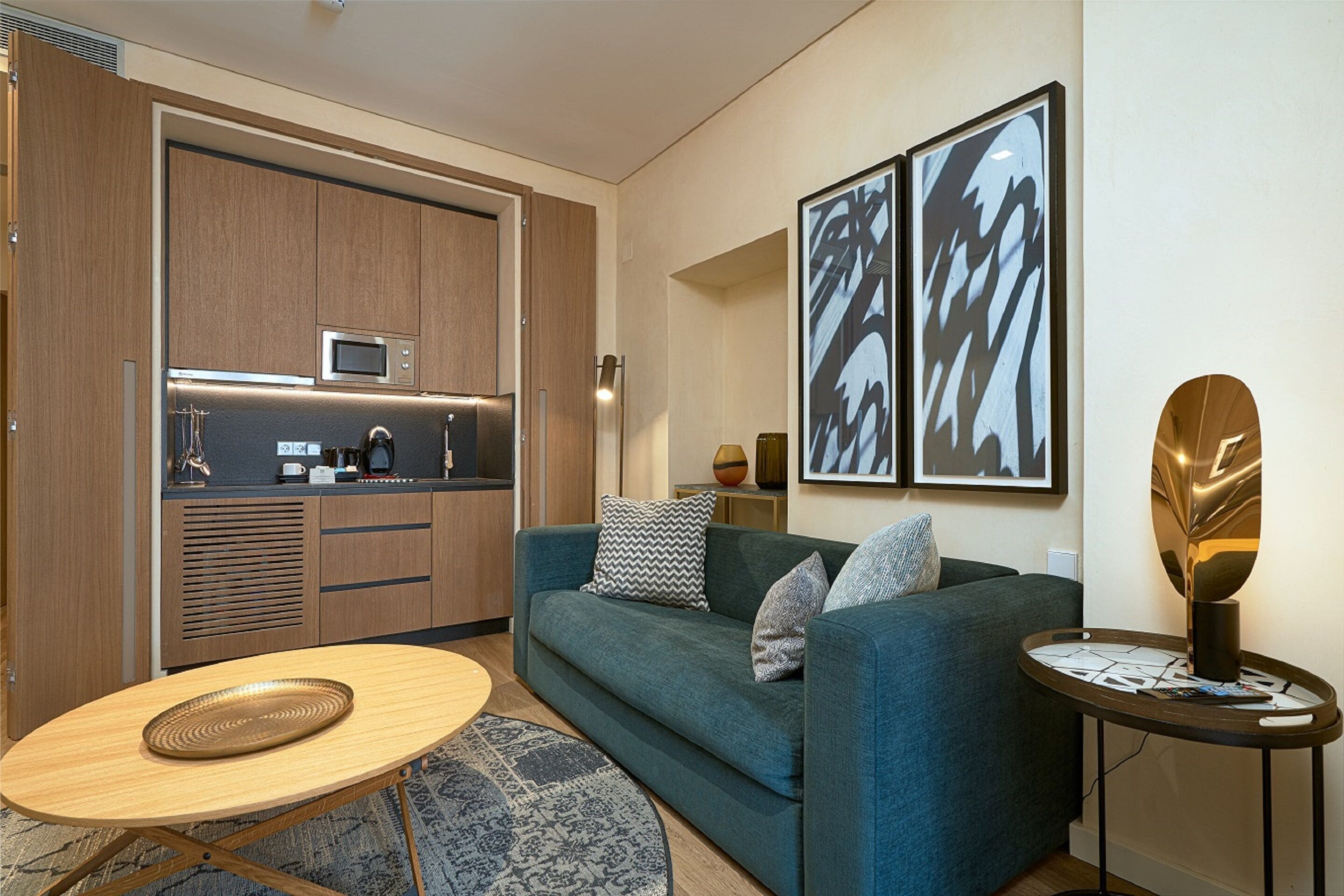 A modern living room with a sofa, coffee table, and a small side table.