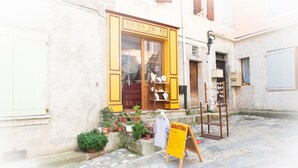 Una botiga amb un rètol que diu "Jolies Filles" i articles exposats a l'exterior.