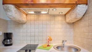 A kitchen with a built-in stove, a sink, and a coffee maker. - Hedera Estate, Hedera A21 Apartment (Dubrovnik)