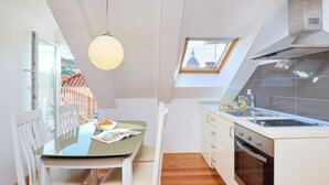 A compact kitchen with a dining area, a skylight, and a view of the cityscape. - Hedera Estate, Hedera A31 Apartment (Dubrovnik)