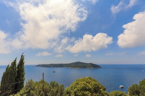 A coastal landscape with a clear sky, a small island, and calm sea. - Hedera Estate, Hedera A13 (Dubrovnik)