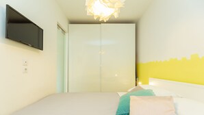 A bedroom with a bed, pillows, a television, and a wardrobe. - Hedera Estate, Hedera A29 (Dubrovnik)