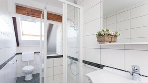 A bathroom with a shower, toilet, sink, and a window. - Hedera Estate, Hedera A5 Apartment (Dubrovnik)