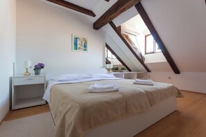 A bedroom with a bed, a nightstand, a bedside table, a mirror, and a window. - Hedera Estate, Hedera A5 Apartment (Dubrovnik)